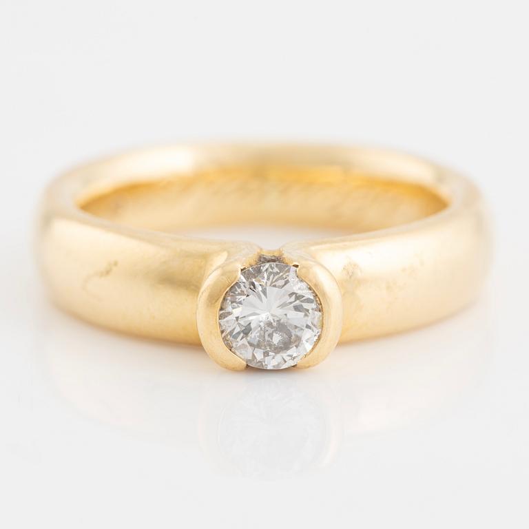 Gold ring with brilliant-cut diamond.