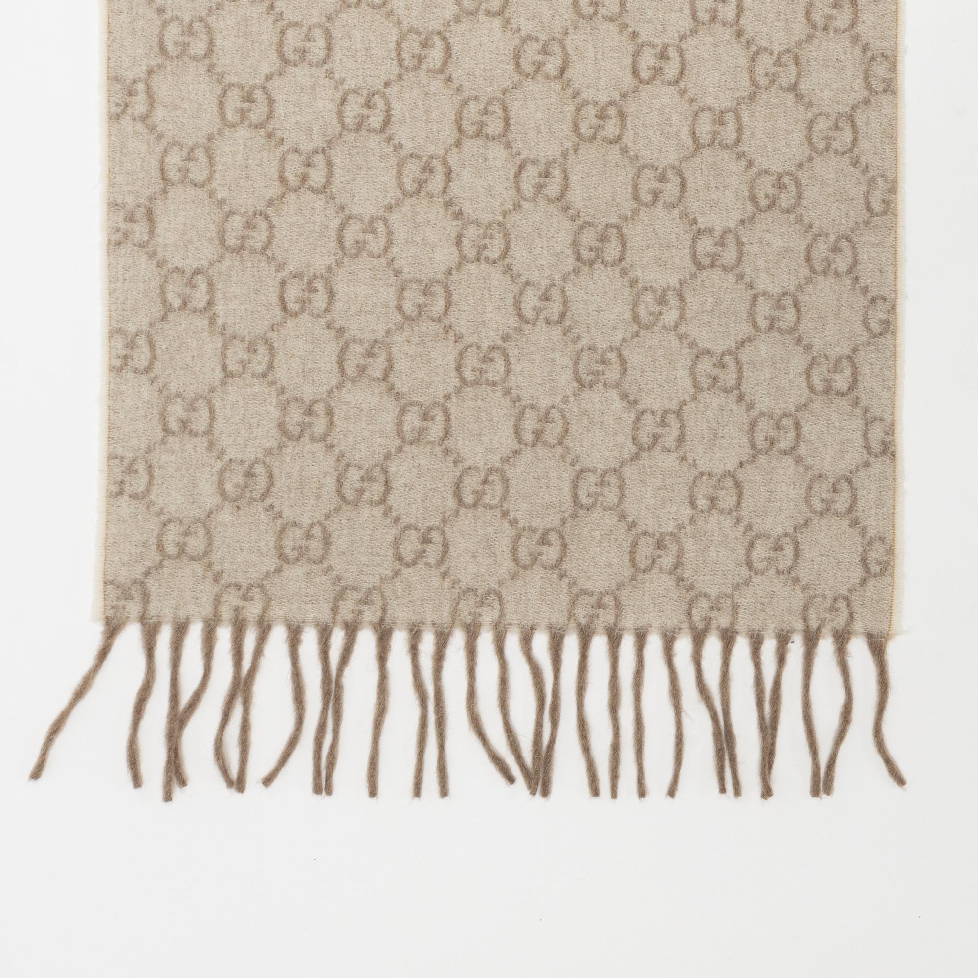 Gucci, a monogram cashmere scarf.