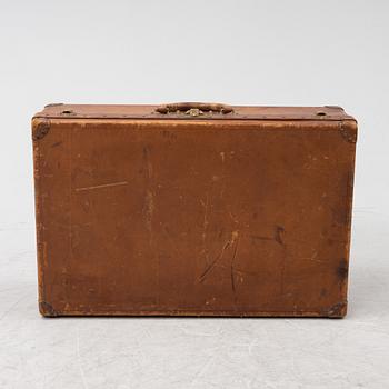 Louis Vuitton, a leather suitcase, first half of the 20th Century.