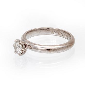 An 18K white gold solitaire ring set with a round brilliant cut diamond by Kaplans, with GIA dossier.