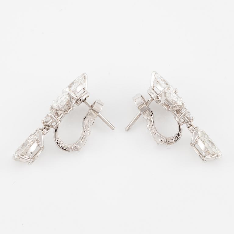 Cartier a pair of earrings platinum set with drop-shaped and round brilliant-cut diamonds.