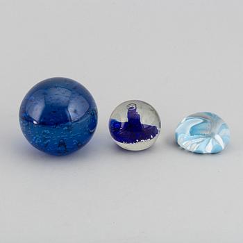 A group of 12 glass paper weights.