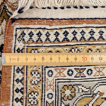 A Ghom, figural, silk rug, c. 205 x 140 cm.