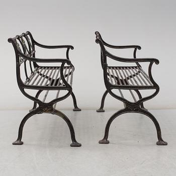 GARDEN SOFAS, a pair, cast iron, empire style, late 19th century.