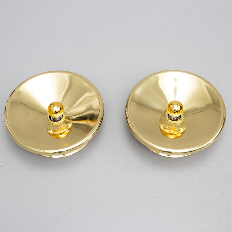 TOM DIXON, a pair of brass wall lamps.