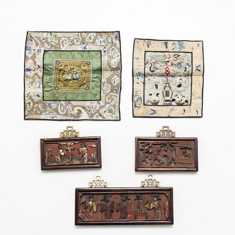 Three Chinese lacquer and wooden panels, two silk embroideries, first half of the 20th century.