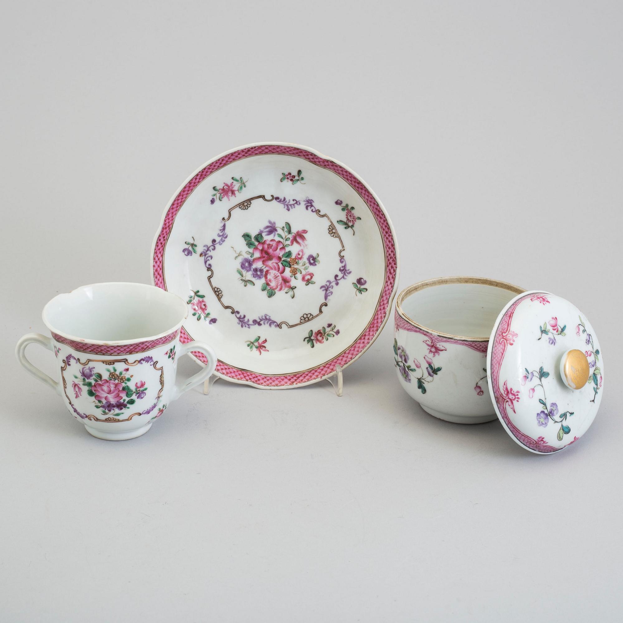 A pair of famille rose cup with stands and a sugar bowl with cover, Qing dynasty, Qianlong (1736-95).
