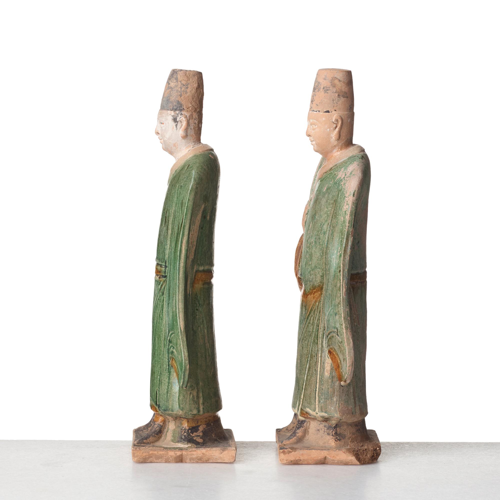 Two green and yellow glazed pottery figures of Ming officials, Ming style, 20th Century.