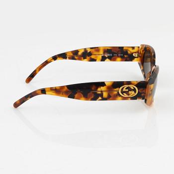 Gucci, a pair of gold tone logo sunglasses.