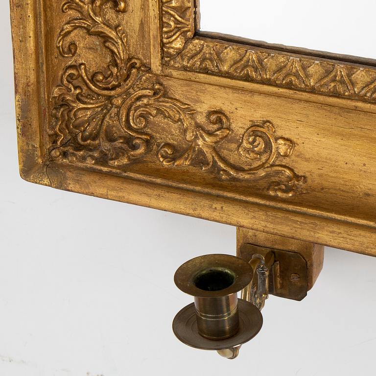 A first half of the 19th century mirror wall sconce.