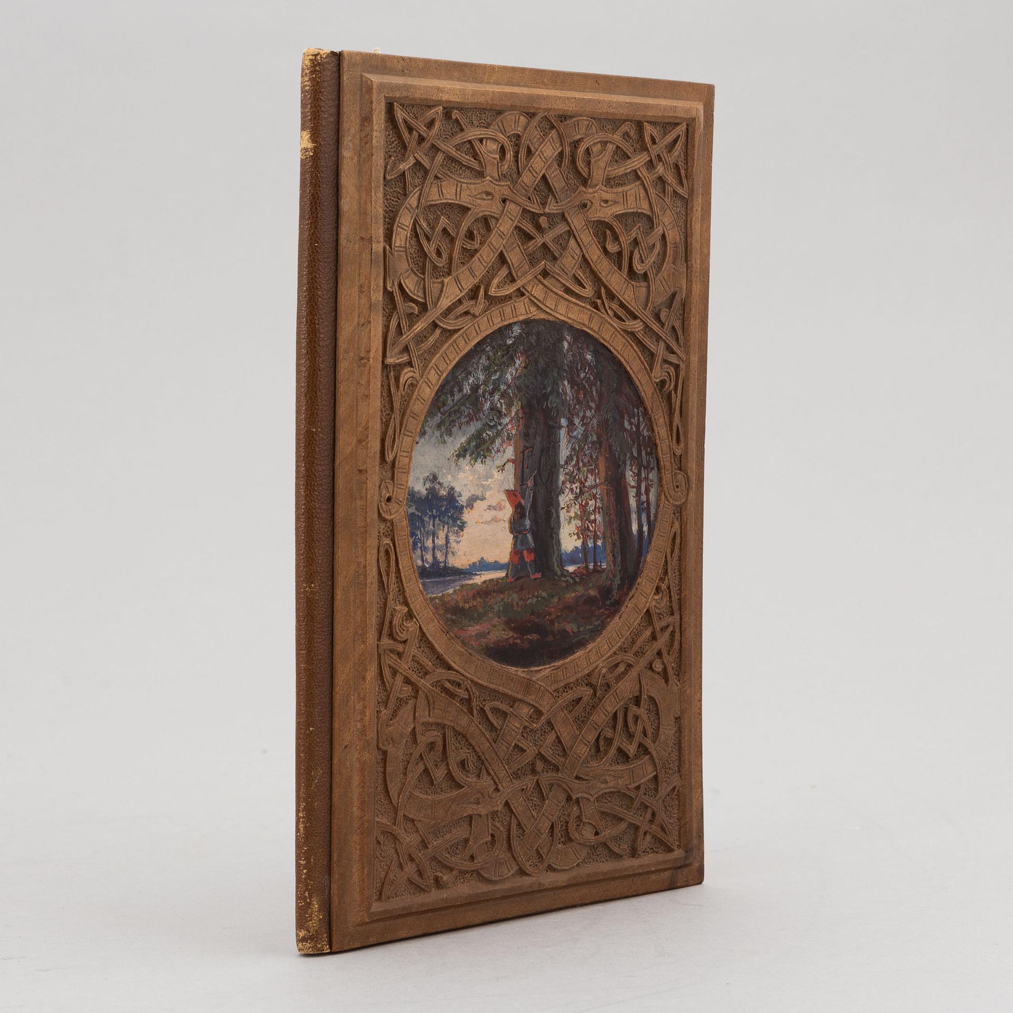 A keepsake book embellished by Ellen Jolin featuring a 'Santa Claus' figure.