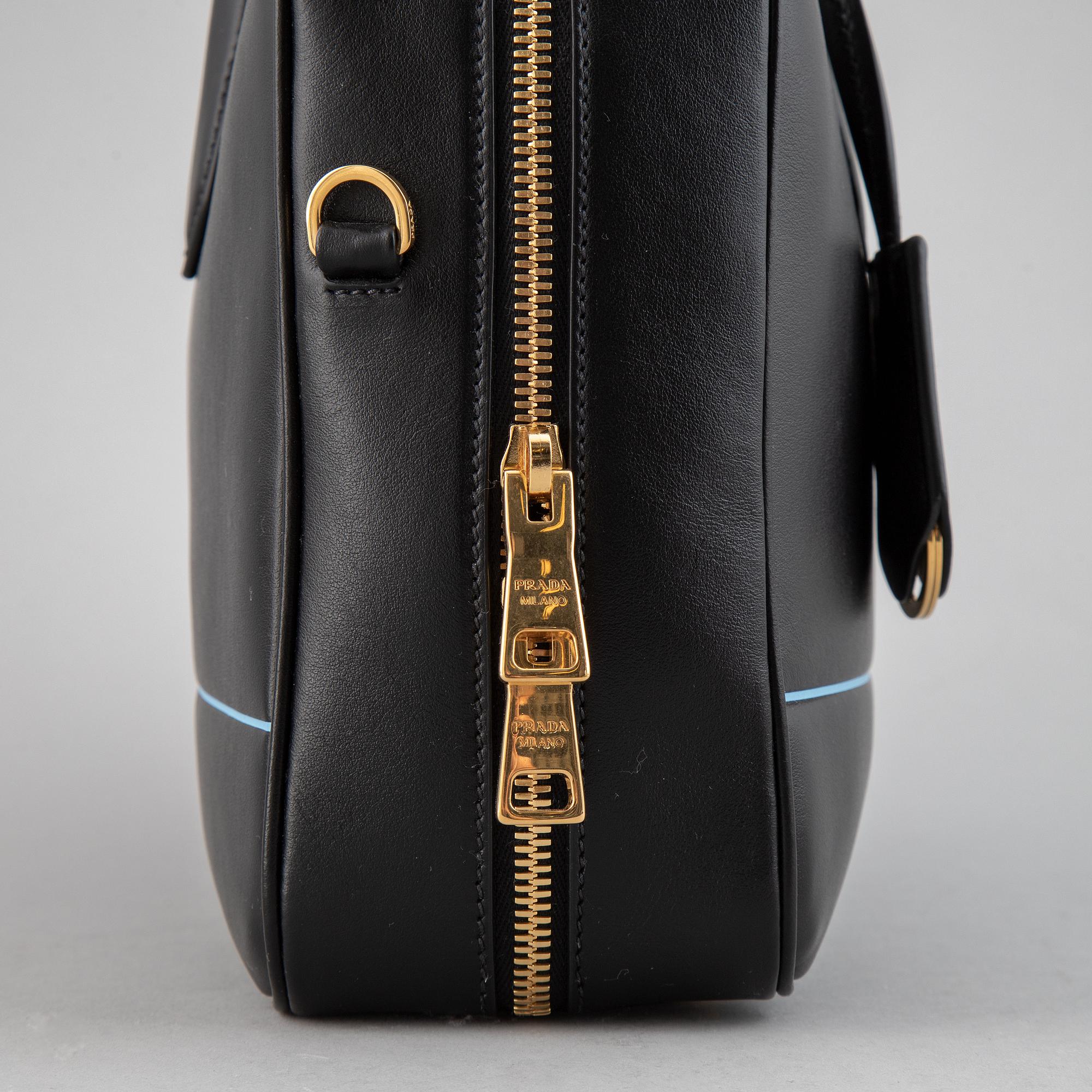 PRADA, a leather bag.