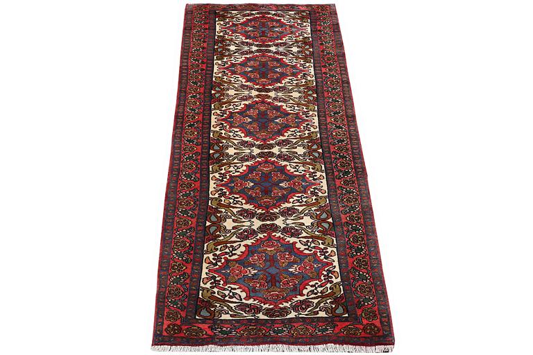 An oriental runner carpet, c. 295 x 95 cm.