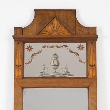 An Empire style mahogany-veneered mirror, around 1900.