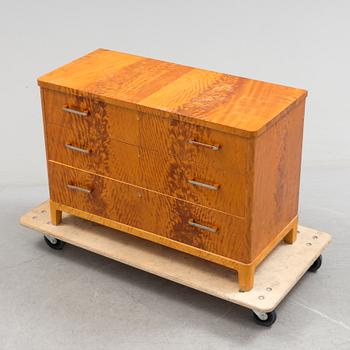 A 1930s art déco birch veneered chest of three drawers.