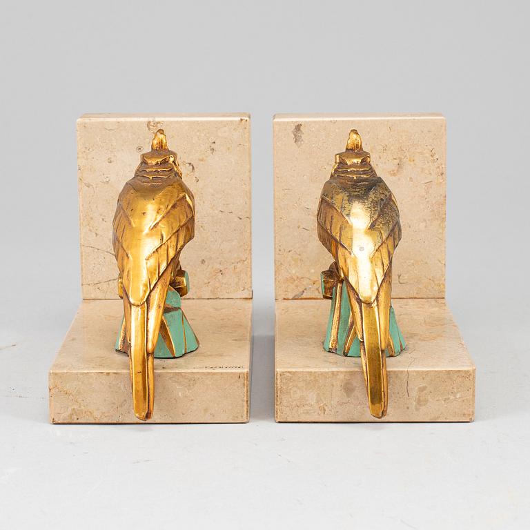 A pair of art déco painted metal and marble books ends, 1930s.