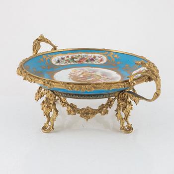 A French porcelain and brass centrepiece, second half of the 19th Century.