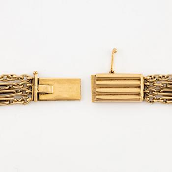 A W.A. Bolin necklace in 18K gold with pearls and white discs.