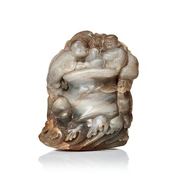 671. A carved Chinese nephrite boulder with a buddai seated on top of a cliff.