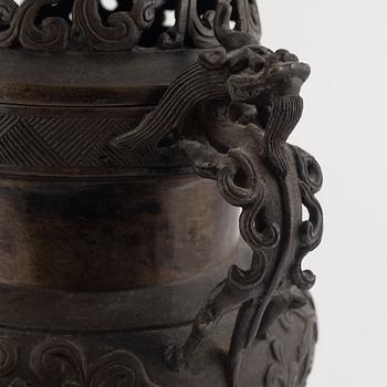 A tripod bronze censer with cover, Qing dynasty, 19th century.