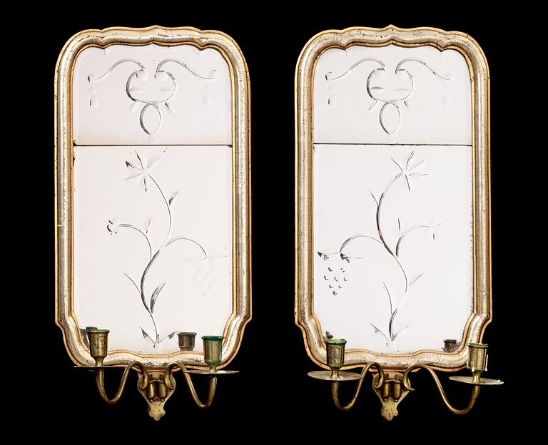 A pair of Swedish Rococo 18th century two-light girandole mirrors.