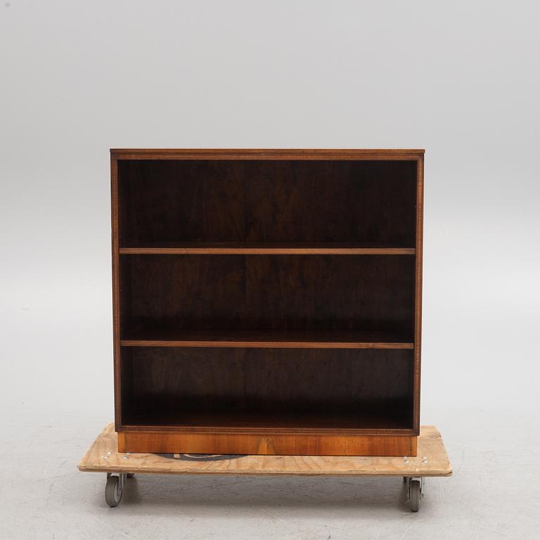 A 1930s wanlut and rosewood veneered  bookcase.