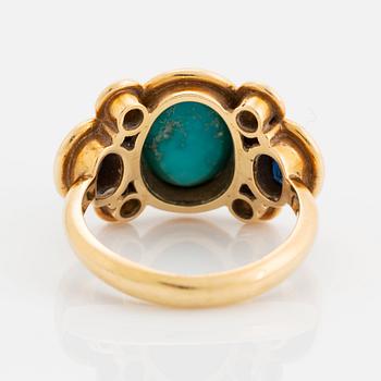 An 18K gold and turquoise Grima ring set with faceted sapphires and round brilliant-cut diamonds.