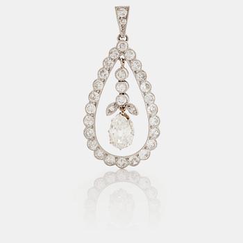 A pendant set with a pear cut diamond surrounded by old cut diamonds.