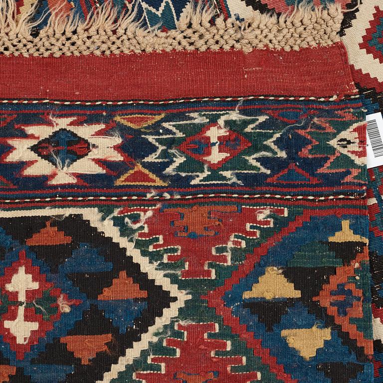 A CARPET, AN ANTIQUE AZERI KILIM, probably a Shirvan, ca 250 x 117,5 cm.