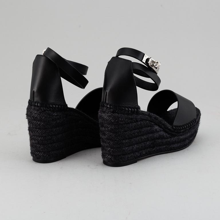 HERMÈS, a pair of black leather 'Tivoli' wedge sandals, 2019, size 38.