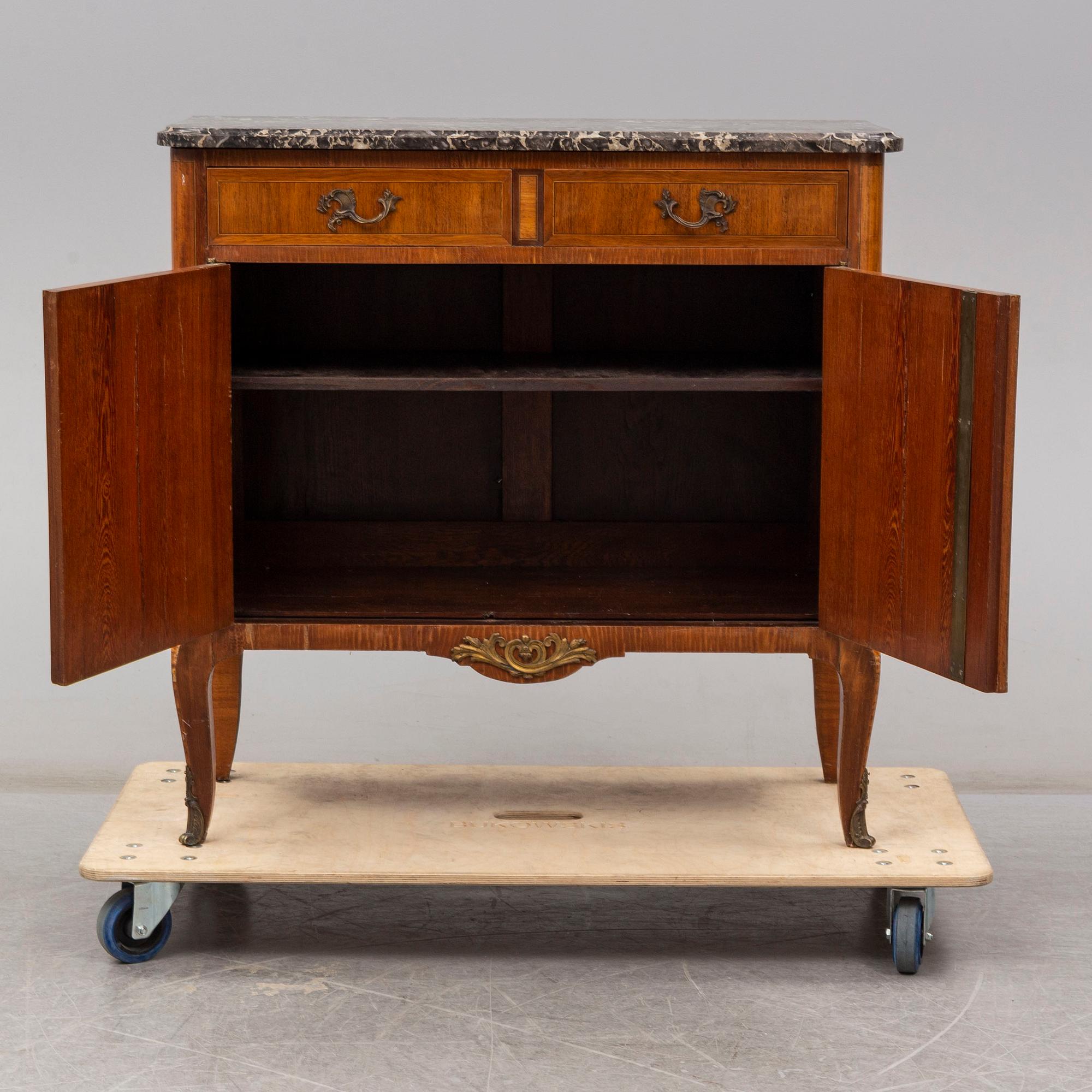 A French Louis XVI-style cupboard, ca 1900.