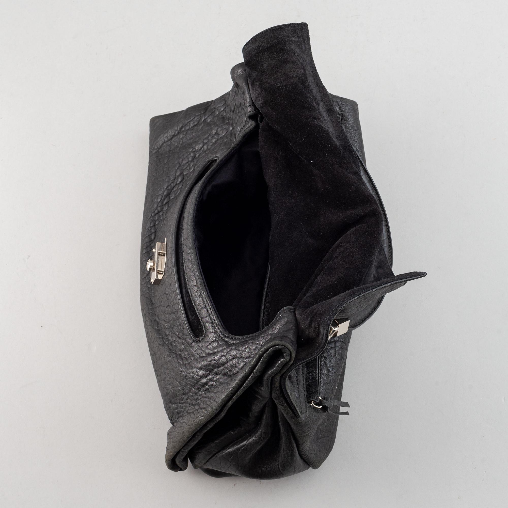 Yves Saint Laurent, a black leather bag.
