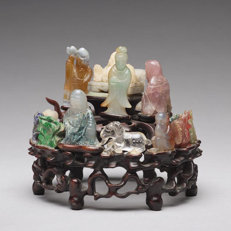 An arrangement of stone sculptures on a wooden stand, China 20th Century.