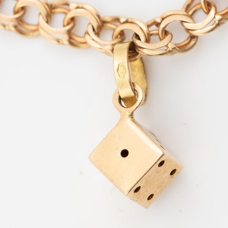 Bracelet, 18K gold bismarck link. With charms.