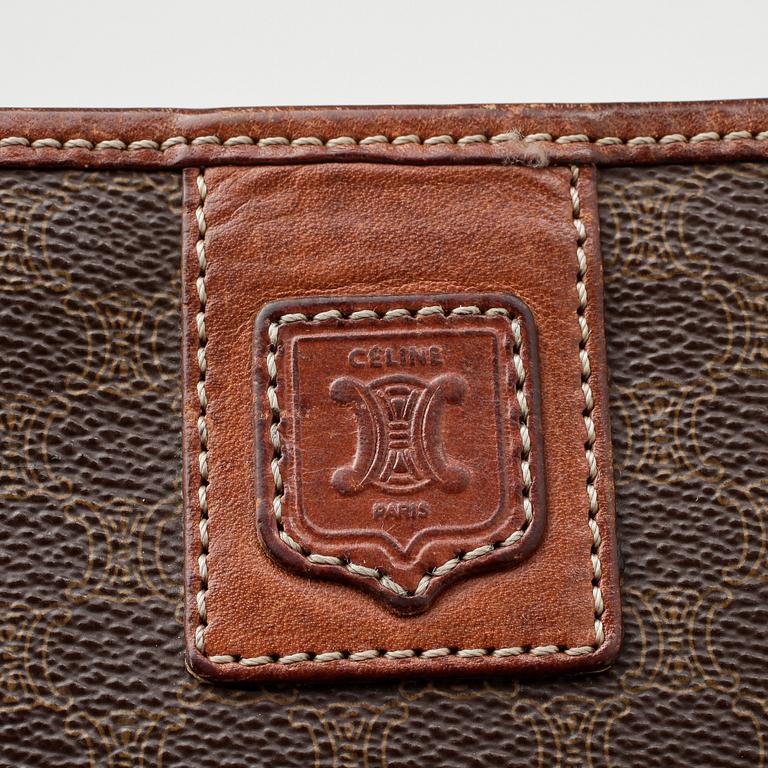 CÉLINE, a brown coated monogram canvas clutch bag.