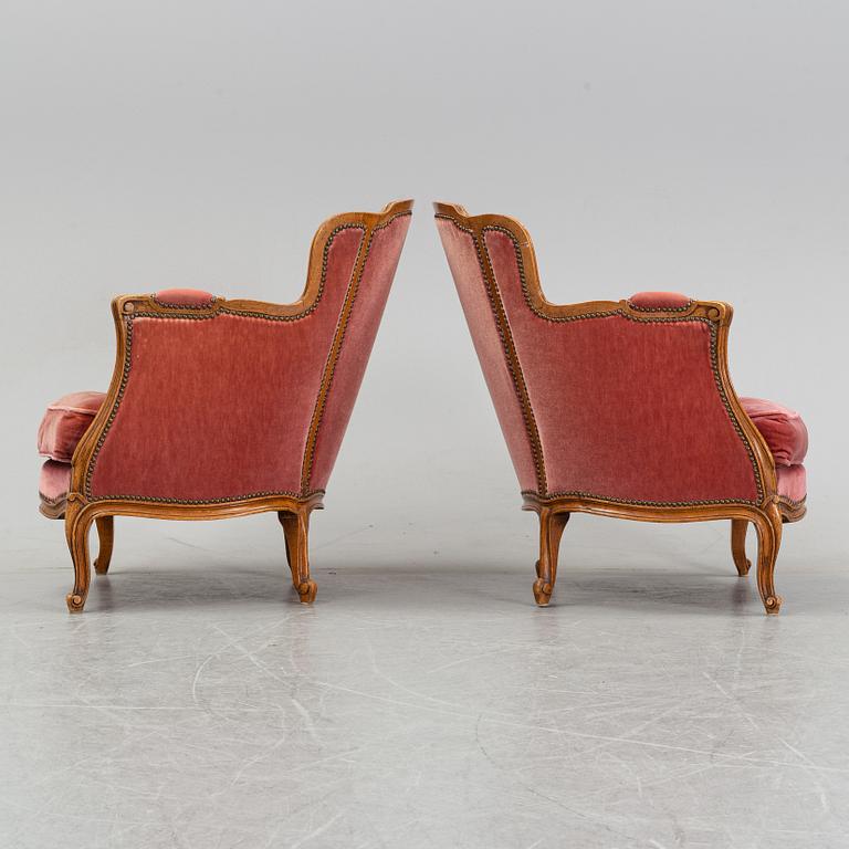 A pair of rococo style easy chairs from around the year 1900.