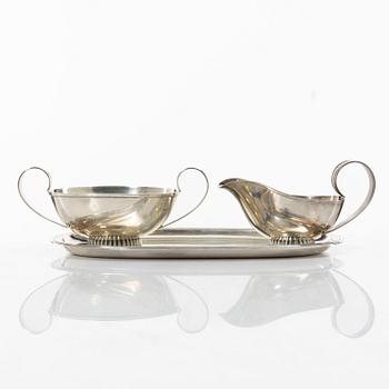 Three pieces of silver, a sugar bowl, a milk jug, and a tray. CG Hallberg 1953 & K & EC 1949.