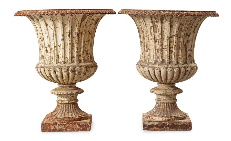 A pair of English 1860's iron garden urns.