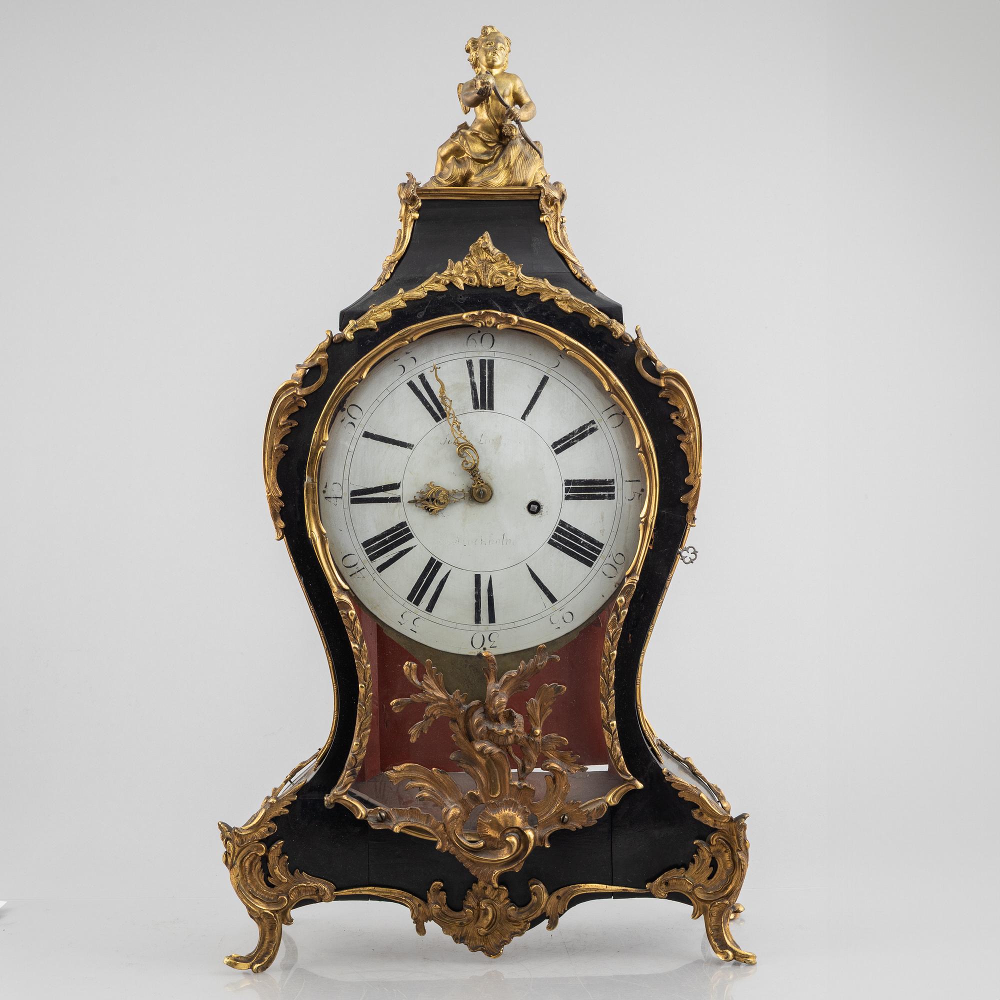 Clock, Rococo style with partially older parts, around the year 1900.