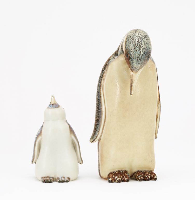 Two Gunnar Nylund stoneware figures depicting a penguin mother with child, Rörstrand.