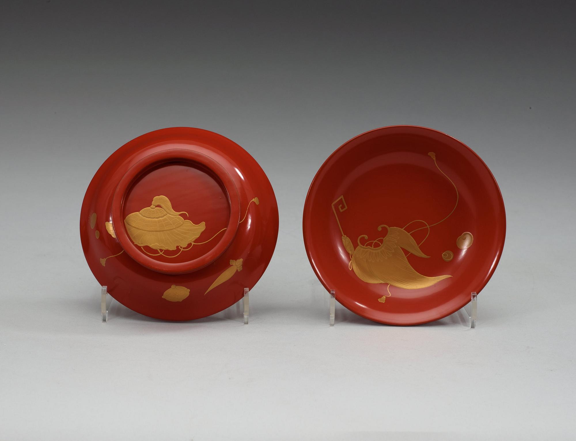 A set of eight red lacquered Japanese bowls with covers, first half of 20th Century.