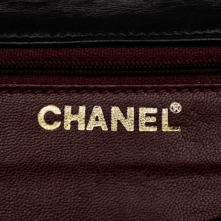 CHANEL, a quilted black leather shoulder bag, "Flap bag maxi".