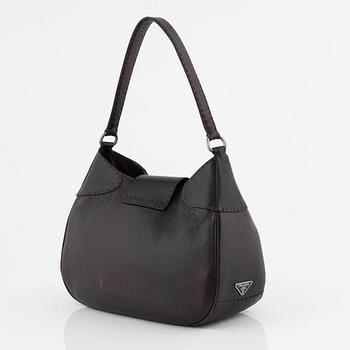 Prada, a brown leather bag.