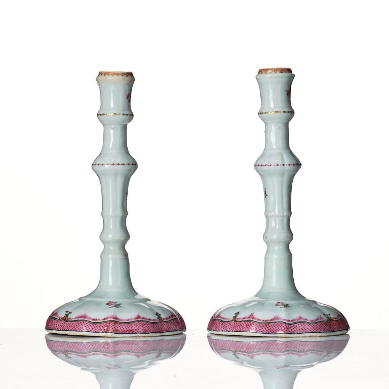 A pair of famille rose candle sticks, Qing dynasty, Qianlong (1736-95).