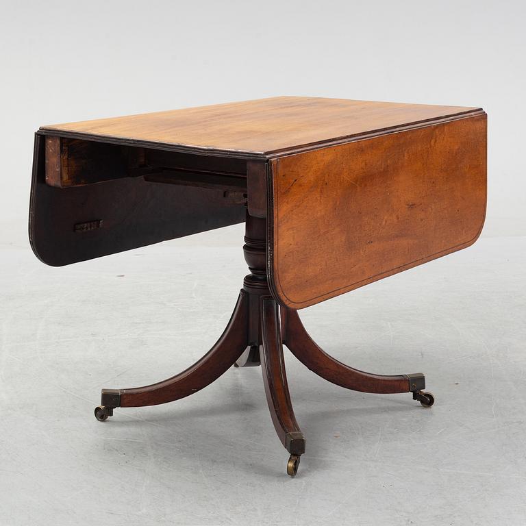 A mahognay drop leaf table, end of the 19th Century.