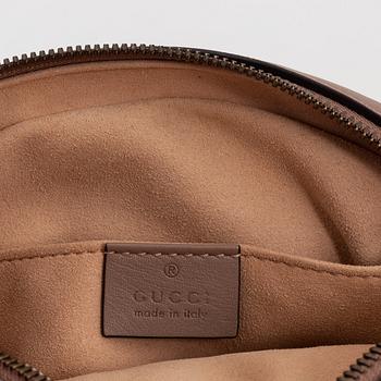 Gucci, a leather belt bag.