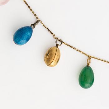 Necklace with jeweled egg, 14K gold and metal.