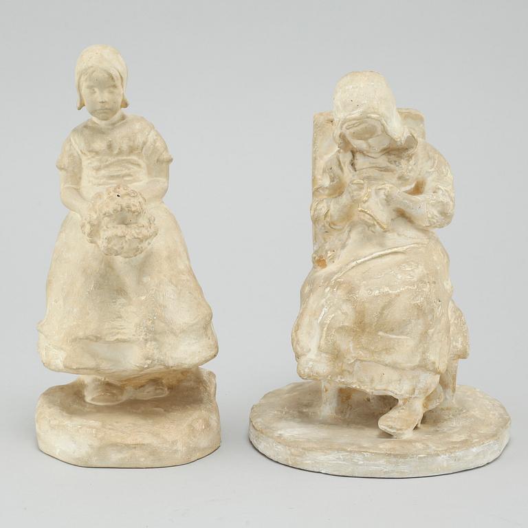 two plaster figurines, signed.