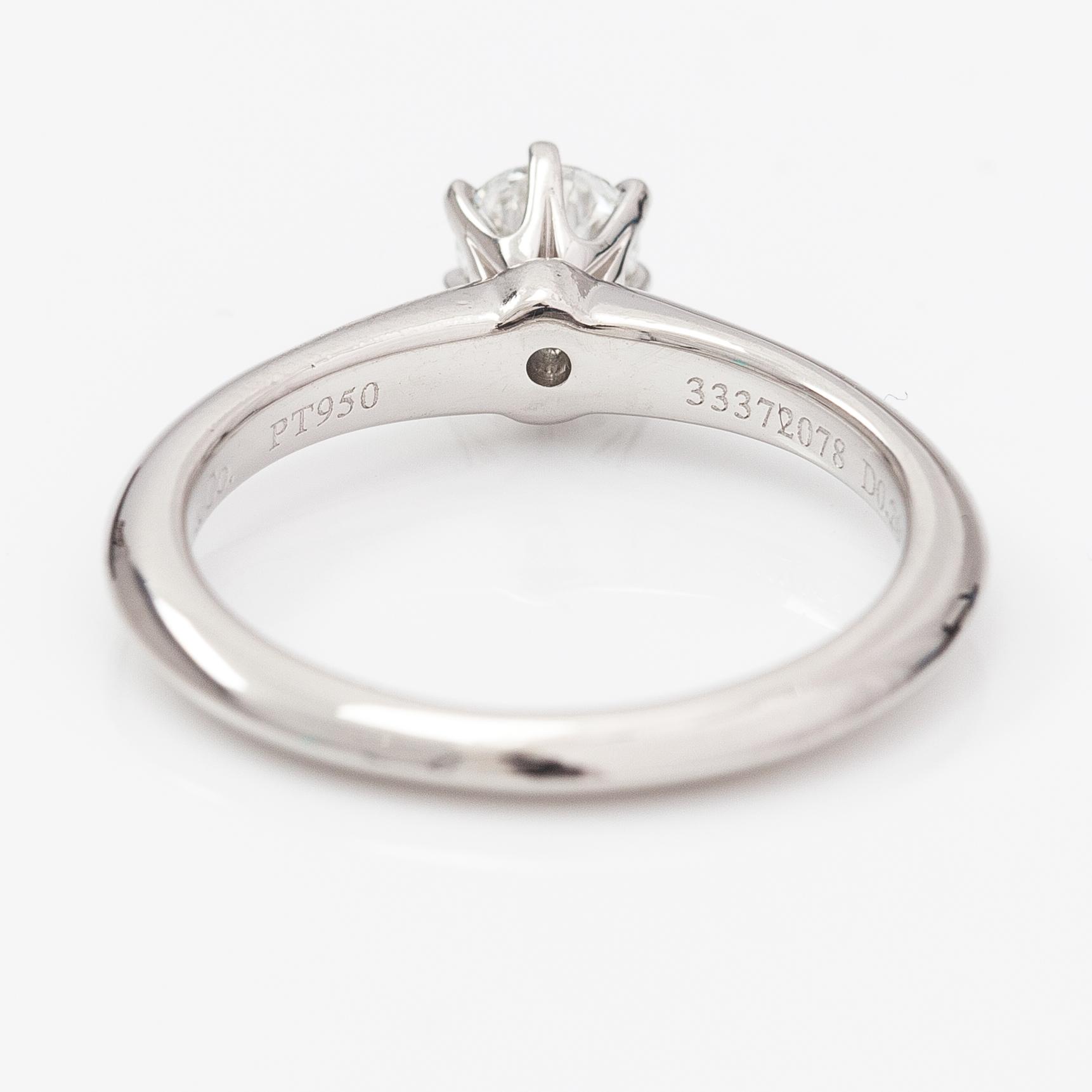 Tiffany & Co, A platinum ring with a ca. 0.26 ct diamond.