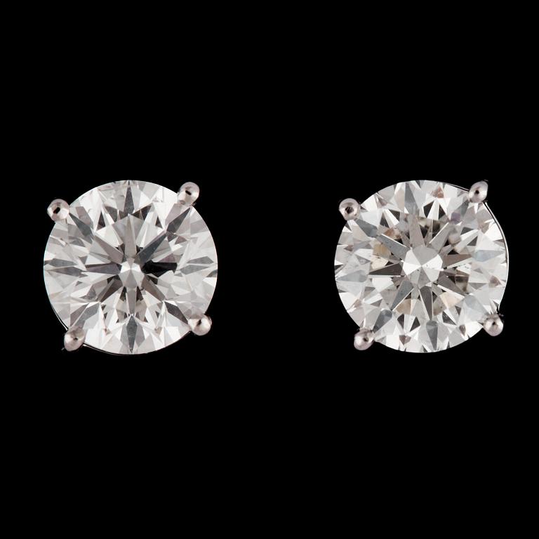 A pair of brilliant cut diamond studs, 2.02 cts and 2.01 cts.